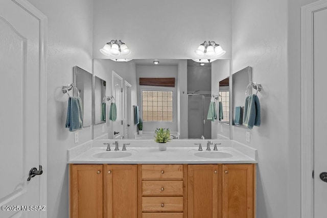 full bath featuring double vanity and a shower stall