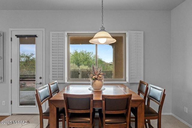 dining space with light tile patterned flooring and baseboards
