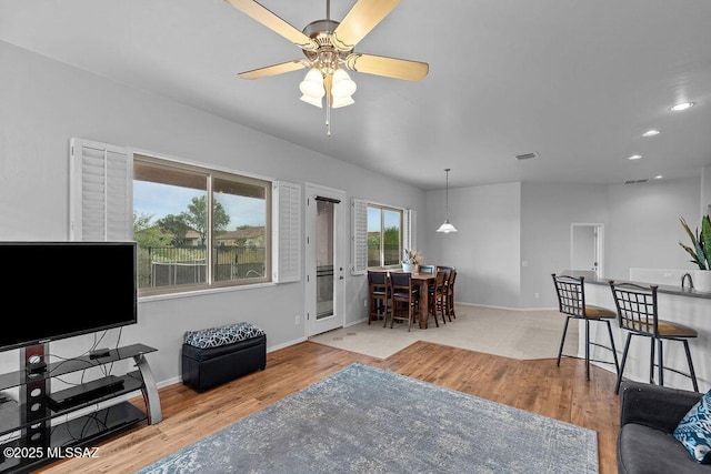 living room with a ceiling fan, wood finished floors, baseboards, and recessed lighting
