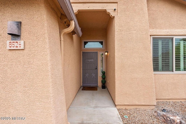 property entrance with stucco siding
