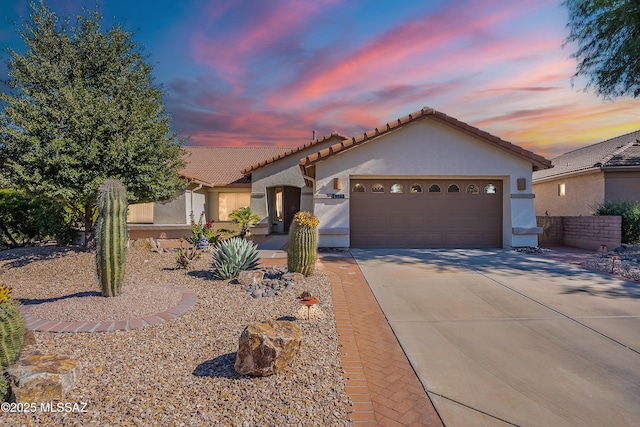 1328 N Mahogany Gulch Ln, Green Valley, AZ 85614 - view of front of property with stucco siding, concrete driveway, an attached garage, and a tile roof