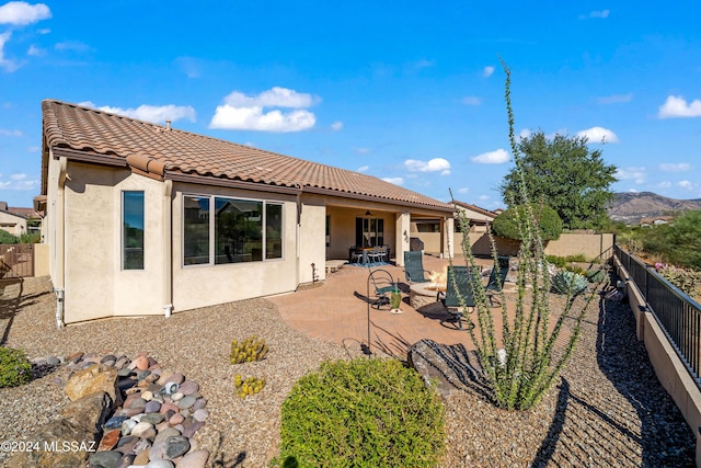 62817 E Sandlewood Rd, Saddlebrooke, AZ 85739 - rear view of property featuring stucco siding, a tiled roof, a fenced backyard, and a patio