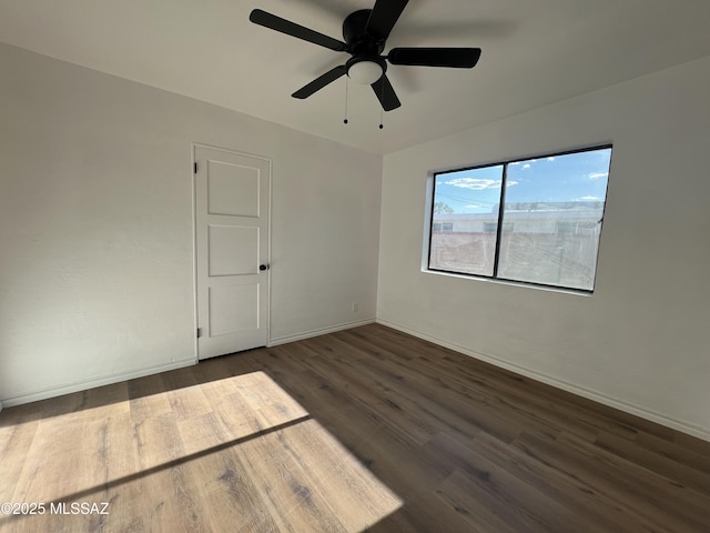 2838 E Beverly Dr, Tucson, AZ 85716 - unfurnished room featuring dark wood-type flooring, baseboards, and a ceiling fan