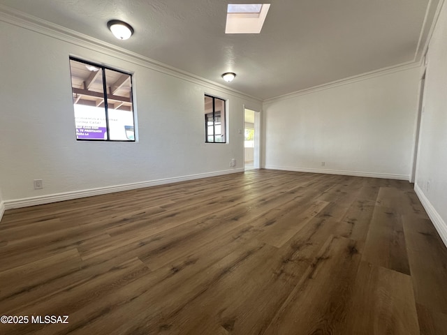 2838 E Beverly Dr, Tucson, AZ 85716 - empty room featuring crown molding, plenty of natural light, wood finished floors, a skylight, and baseboards