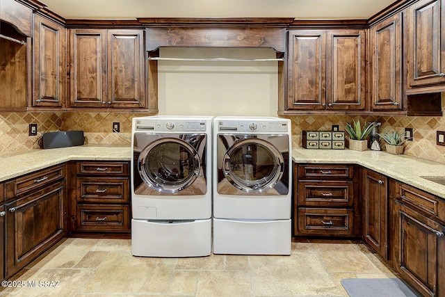 6015 N Camino Preciado, Tucson, AZ 85718 - laundry room featuring independent washer and dryer, light stone finish flooring, and cabinet space
