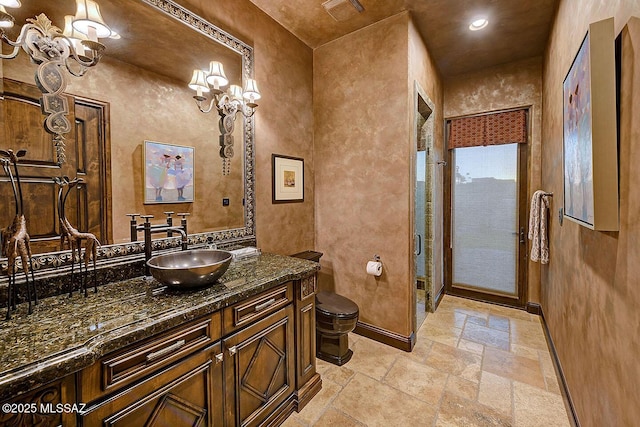 6015 N Camino Preciado, Tucson, AZ 85718 - full bathroom featuring stone tile floors, baseboards, toilet, vanity, and a shower stall