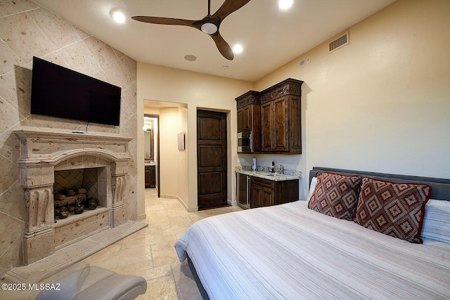 6015 N Camino Preciado, Tucson, AZ 85718 - bedroom featuring recessed lighting, a fireplace, ceiling fan, and stone tile flooring