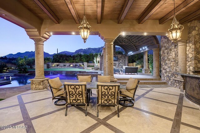 6015 N Camino Preciado, Tucson, AZ 85718 - view of patio with a mountain view, outdoor dining area, and a pool with connected hot tub