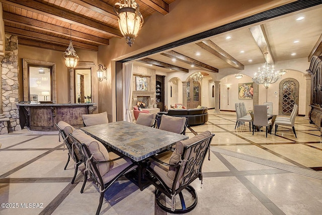 6015 N Camino Preciado, Tucson, AZ 85718 - dining area with inlaid floor details, a chandelier, arched walkways, beamed ceiling, and wood ceiling