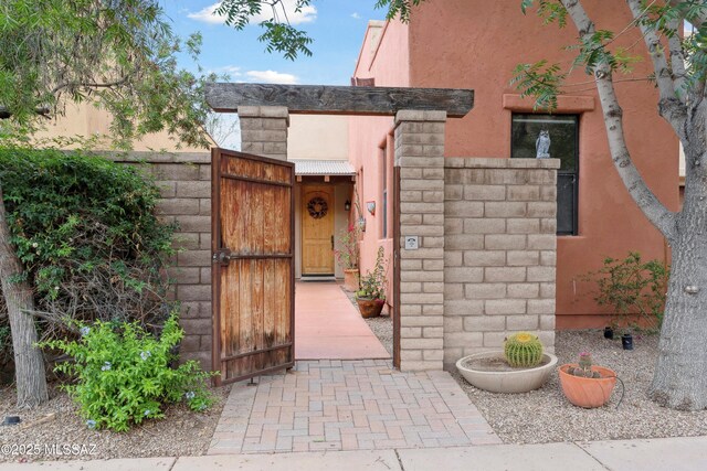 385 E Cedarvale Rd, Tucson, AZ 85704 - entrance to property featuring a gate and stucco siding