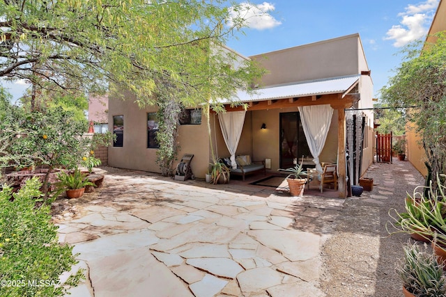 385 E Cedarvale Rd, Tucson, AZ 85704 - back of property with stucco siding and a patio