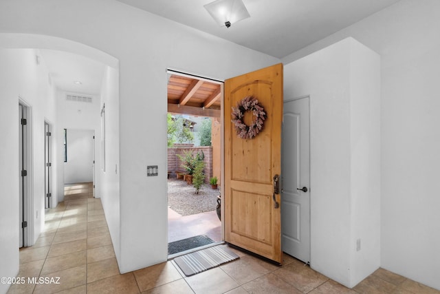 385 E Cedarvale Rd, Tucson, AZ 85704 - foyer with arched walkways, light tile patterned floors, and beamed ceiling