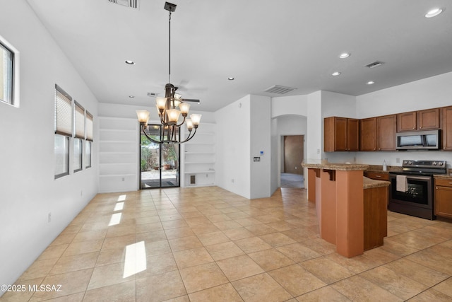 385 E Cedarvale Rd, Tucson, AZ 85704 - kitchen featuring stainless steel appliances, arched walkways, recessed lighting, a chandelier, and light tile patterned floors