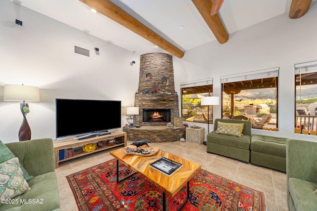 tiled living area with beam ceiling, a fireplace, and a high ceiling