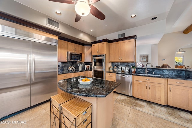 kitchen with stainless steel appliances, a sink, light tile patterned floors, ceiling fan, and tasteful backsplash