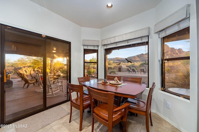 dining room featuring light tile patterned floors and a mountain view