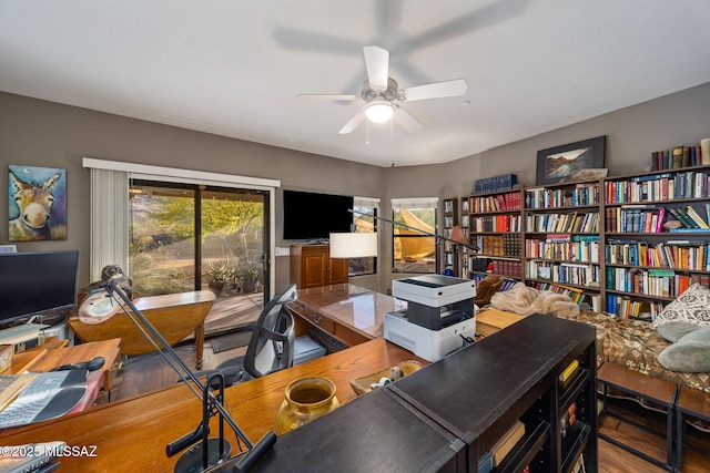 office area with a ceiling fan and wood finished floors