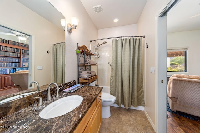full bathroom with ceiling fan, toilet, vanity, tile patterned flooring, and shower / bathtub combination with curtain