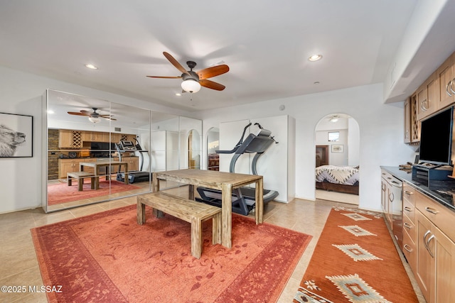 dining space featuring arched walkways, ceiling fan, recessed lighting, and light tile patterned flooring