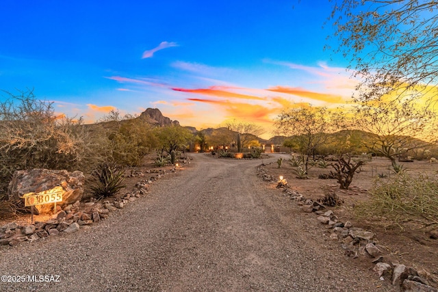 view of dirt / gravel road featuring a mountain view