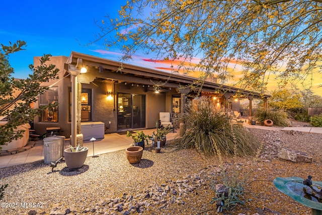 back of house featuring a patio and stucco siding