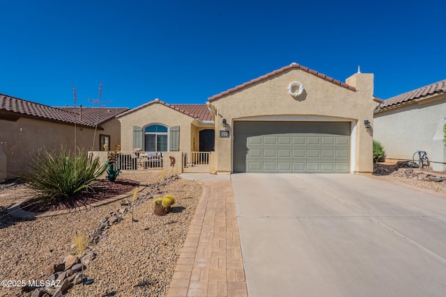 711 W Camino Del Rosal, Sahuarita, AZ 85629 - mediterranean / spanish home with stucco siding, an attached garage, driveway, a tile roof, and fence