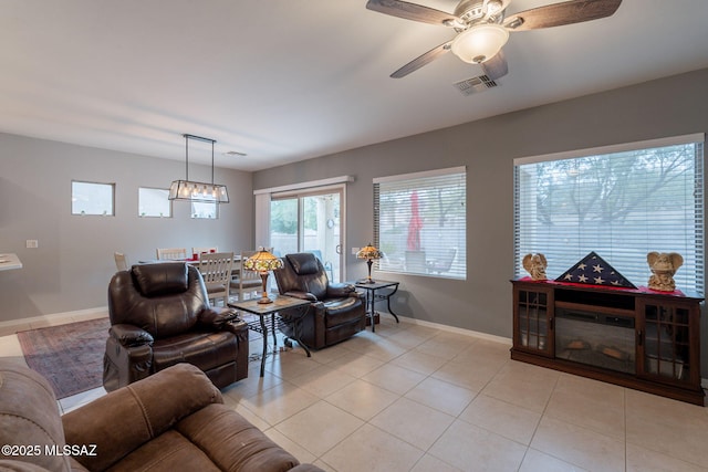 711 W Camino Del Rosal, Sahuarita, AZ 85629 - living area featuring baseboards, a ceiling fan, and light tile patterned floors