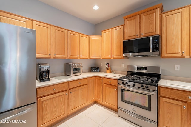 711 W Camino Del Rosal, Sahuarita, AZ 85629 - kitchen with appliances with stainless steel finishes, light tile patterned floors, light countertops, light brown cabinets, and recessed lighting