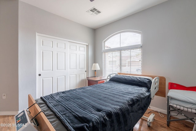 711 W Camino Del Rosal, Sahuarita, AZ 85629 - bedroom with baseboards, wood finished floors, and a closet