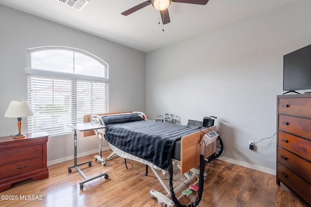 711 W Camino Del Rosal, Sahuarita, AZ 85629 - bedroom with baseboards, wood finished floors, and a ceiling fan