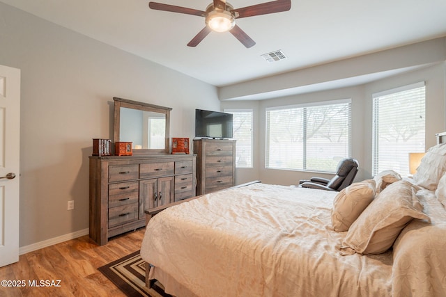 711 W Camino Del Rosal, Sahuarita, AZ 85629 - bedroom featuring baseboards, light wood-type flooring, and a ceiling fan