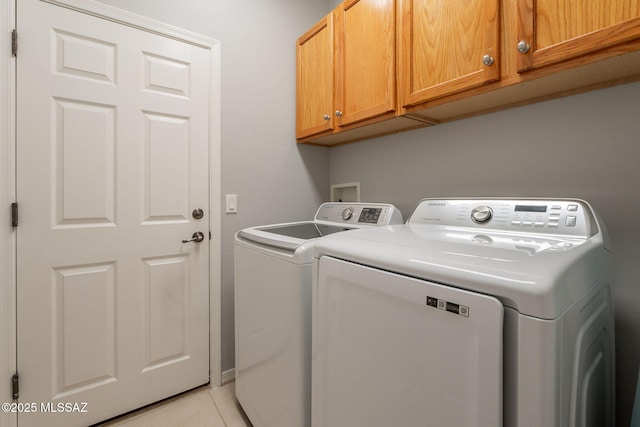 711 W Camino Del Rosal, Sahuarita, AZ 85629 - washroom featuring cabinet space, washing machine and dryer, and light tile patterned floors
