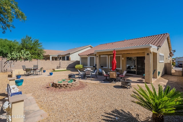 711 W Camino Del Rosal, Sahuarita, AZ 85629 - back of house featuring an outdoor fire pit, a tiled roof, a fenced backyard, and a patio area