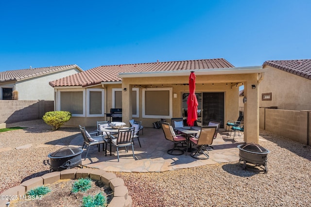 711 W Camino Del Rosal, Sahuarita, AZ 85629 - rear view of property with a fire pit, a tiled roof, and stucco siding