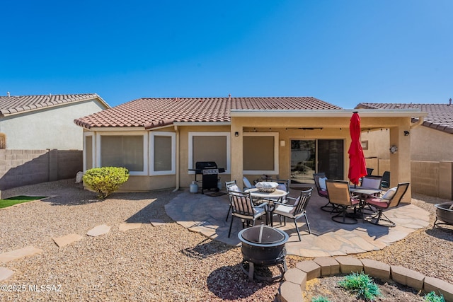 711 W Camino Del Rosal, Sahuarita, AZ 85629 - rear view of house featuring a fenced backyard, a tiled roof, stucco siding, a patio, and outdoor dining space