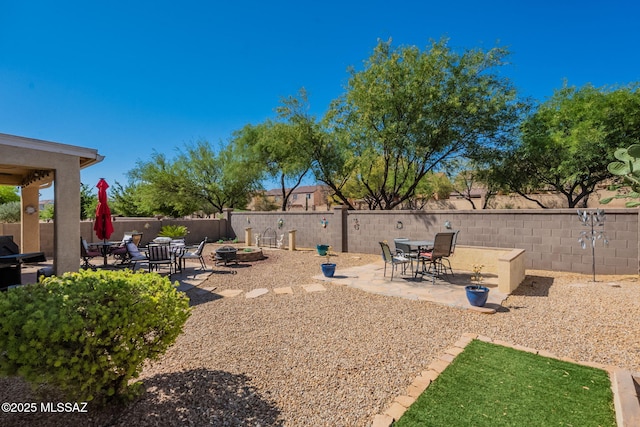 711 W Camino Del Rosal, Sahuarita, AZ 85629 - view of patio / terrace with a fenced backyard and a fire pit