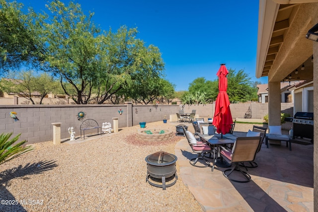 711 W Camino Del Rosal, Sahuarita, AZ 85629 - view of patio featuring a fire pit, outdoor dining area, a fenced backyard, and grilling area