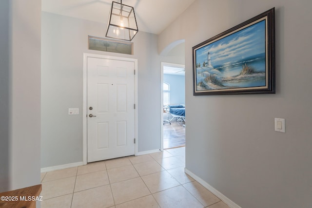 711 W Camino Del Rosal, Sahuarita, AZ 85629 - entrance foyer featuring arched walkways, baseboards, and light tile patterned flooring