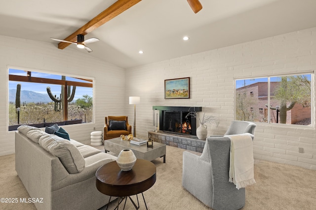 6891 N Camino Verde, Tucson, AZ 85743 - carpeted living area with a ceiling fan, a tiled fireplace, recessed lighting, and vaulted ceiling with beams