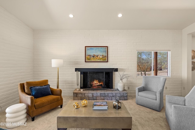 6891 N Camino Verde, Tucson, AZ 85743 - carpeted living room featuring brick wall, a fireplace, and recessed lighting