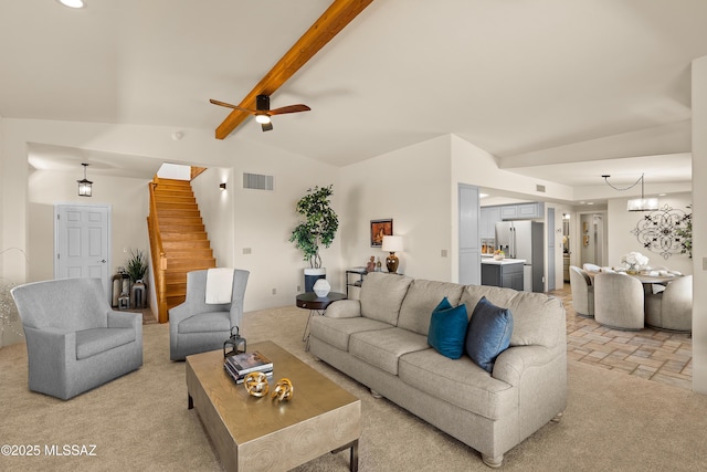 6891 N Camino Verde, Tucson, AZ 85743 - living room with ceiling fan with notable chandelier, visible vents, stairway, light carpet, and vaulted ceiling with beams