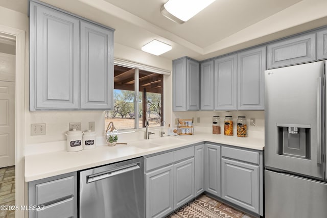 6891 N Camino Verde, Tucson, AZ 85743 - kitchen featuring a sink, light countertops, gray cabinets, and appliances with stainless steel finishes