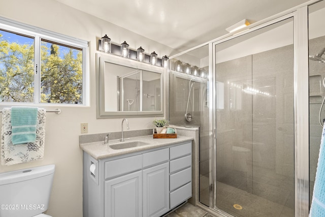 6891 N Camino Verde, Tucson, AZ 85743 - full bathroom with vanity, toilet, a shower stall, and a healthy amount of sunlight