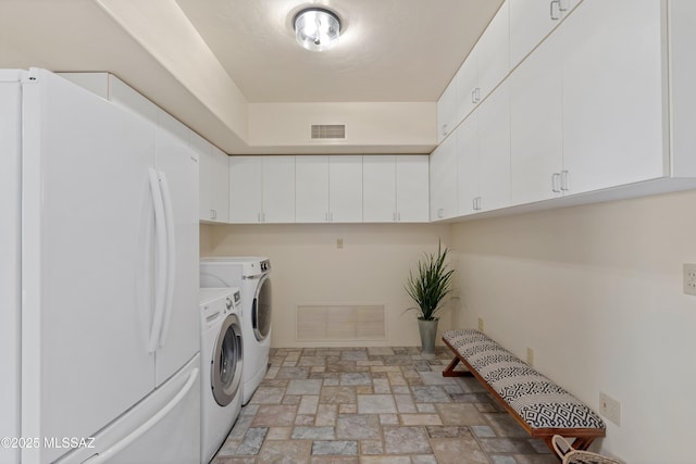 6891 N Camino Verde, Tucson, AZ 85743 - clothes washing area with stone finish flooring, independent washer and dryer, and visible vents