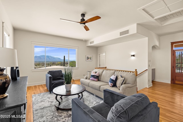 6891 N Camino Verde, Tucson, AZ 85743 - living room featuring a wealth of natural light, visible vents, ceiling fan, and arched walkways