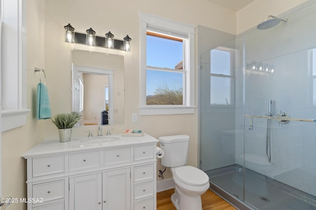 6891 N Camino Verde, Tucson, AZ 85743 - full bathroom with vanity, toilet, wood finished floors, and a stall shower