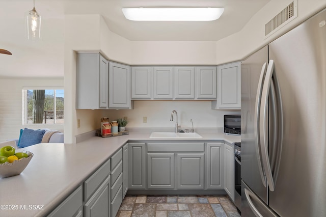 6891 N Camino Verde, Tucson, AZ 85743 - kitchen with gray cabinetry, stainless steel appliances, visible vents, and a sink