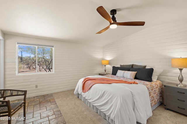 6891 N Camino Verde, Tucson, AZ 85743 - bedroom with vaulted ceiling, a ceiling fan, and stone finish floor