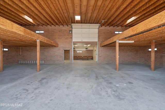 6891 N Camino Verde, Tucson, AZ 85743 - interior space with brick wall, unfinished concrete floors, and a garage