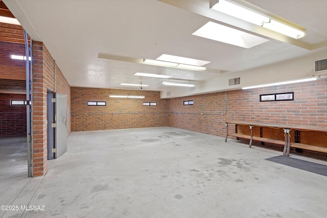 6891 N Camino Verde, Tucson, AZ 85743 - interior space featuring brick wall and visible vents